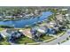 An aerial view of a waterfront property with a private boat dock, a pool, and mature landscaping at 4054 Rocky Shores Dr, Tampa, FL 33634