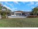 The backyard features a sparkling pool, lush lawn, and stylish outdoor seating, creating an ideal space for entertaining at 4054 Rocky Shores Dr, Tampa, FL 33634