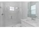 The new bright bathroom features white tile in the shower and marble countertop at 4054 Rocky Shores Dr, Tampa, FL 33634