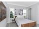 Bedroom features a large floral print, light-colored walls, and two windows with white curtains at 4054 Rocky Shores Dr, Tampa, FL 33634