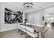 Contemporary dining room with unique chandelier, artistic wall decor and hardwood floors at 4054 Rocky Shores Dr, Tampa, FL 33634