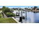 Waterfront property featuring a private dock and boat lift for easy access to boating and water activities at 4054 Rocky Shores Dr, Tampa, FL 33634