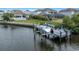 Waterfront property featuring a private dock and boat lift for easy access to boating and water activities at 4054 Rocky Shores Dr, Tampa, FL 33634