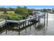 Waterfront property featuring a private dock and boat lift for easy access to boating and water activities at 4054 Rocky Shores Dr, Tampa, FL 33634