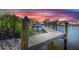 Private boat dock on the canal with a boat lift during a picturesque sunset at 4054 Rocky Shores Dr, Tampa, FL 33634