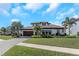Beautiful single-Gathering home with a well-manicured lawn and tropical landscaping at 4054 Rocky Shores Dr, Tampa, FL 33634