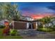 Stunning single-story home with three-car garage, brick driveway, and mature landscaping at 4054 Rocky Shores Dr, Tampa, FL 33634