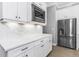 Modern kitchen with stainless steel refrigerator and sleek countertops at 4054 Rocky Shores Dr, Tampa, FL 33634