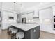 Modern kitchen with quartz counters, stainless appliances, and seating at the island at 4054 Rocky Shores Dr, Tampa, FL 33634