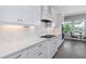 Modern kitchen featuring white cabinets, sleek countertops, and integrated appliances overlooking canal at 4054 Rocky Shores Dr, Tampa, FL 33634