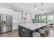 Bright kitchen showcasing an expansive island, stainless steel appliances, and elegant white cabinetry at 4054 Rocky Shores Dr, Tampa, FL 33634