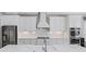 Bright white kitchen featuring stainless steel appliances, designer cabinets, and quartz countertops at 4054 Rocky Shores Dr, Tampa, FL 33634