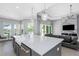 Open concept with Kitchen Island and modern fireplace with integrated TV overlooking canal at 4054 Rocky Shores Dr, Tampa, FL 33634