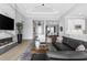 Bright open-concept living room featuring hardwood floors and a modern fireplace at 4054 Rocky Shores Dr, Tampa, FL 33634