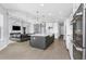 Open concept kitchen with a large island and a marble fireplace in the living room at 4054 Rocky Shores Dr, Tampa, FL 33634