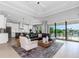 Open-concept living room with comfortable seating, stylish decor, and sliding glass doors at 4054 Rocky Shores Dr, Tampa, FL 33634