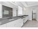 Bright main bathroom with white cabinets, gray countertops, and a glass enclosed shower at 4054 Rocky Shores Dr, Tampa, FL 33634