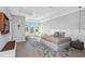 Contemporary main bedroom featuring a sitting area, tray ceiling, and water view at 4054 Rocky Shores Dr, Tampa, FL 33634