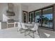 Covered patio features a modern outdoor kitchen with stainless steel appliances and ample seating for entertaining at 4054 Rocky Shores Dr, Tampa, FL 33634