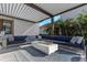 Comfortable covered patio seating area with plush cushions and a modern fireplace feature at 4054 Rocky Shores Dr, Tampa, FL 33634