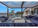 Elegant outdoor patio with a view of the canal, a modern fireplace, and comfortable lounge seating by the pool at 4054 Rocky Shores Dr, Tampa, FL 33634
