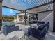 Stylish patio featuring a comfortable seating area, a pool, and an outdoor kitchen with a built-in grill at 4054 Rocky Shores Dr, Tampa, FL 33634