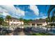 Resort-style pool area with palm trees, lounge chairs, and a covered outdoor bar at 4873 Southern Valley Loop, Brooksville, FL 34601