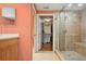 Bathroom featuring a glass-enclosed shower with a tiled surround and a glimpse into the walk-in closet at 501 Mandalay Ave # 601, Clearwater Beach, FL 33767