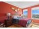 Bedroom featuring warm hardwood floors and a large bed with decorative turtles on the wall at 501 Mandalay Ave # 601, Clearwater Beach, FL 33767