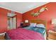 Bedroom features a large bed, bedside tables with lamps, turtle wall decor, and door to the bathroom at 501 Mandalay Ave # 601, Clearwater Beach, FL 33767
