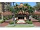 Belle Harbor entrance with tropical plants and a guard house, creating a secure community at 501 Mandalay Ave # 601, Clearwater Beach, FL 33767