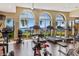 Community gym with workout equipment, water views, and large windows at 501 Mandalay Ave # 601, Clearwater Beach, FL 33767