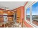 Kitchen and dining space with wood cabinets, updated appliances and plenty of natural light and water views at 501 Mandalay Ave # 601, Clearwater Beach, FL 33767