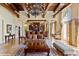 Great room featuring exposed beams, coffered ceiling, built-in bar, and travertine floors at 501 Mandalay Ave # 601, Clearwater Beach, FL 33767