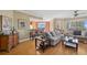 Inviting living room boasts bamboo floors, comfortable seating, and stunning city views from expansive windows at 501 Mandalay Ave # 601, Clearwater Beach, FL 33767