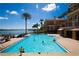 Large community pool with bay views, chairs, and palm trees at 501 Mandalay Ave # 601, Clearwater Beach, FL 33767