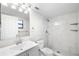 Bright bathroom with white tile, a shower, a white vanity, and a framed mirror at 5618 Baywater Dr # 5618, Tampa, FL 33615