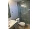 Modern bathroom features a walk-in shower with glass doors, white and gray marbled tile, and a gray vanity at 5618 Baywater Dr # 5618, Tampa, FL 33615