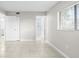 Spacious bedroom with tile floors, white trim, and a view to the adjoining bathroom at 5618 Baywater Dr # 5618, Tampa, FL 33615