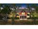 Well-maintained condo building featuring a red accent wall and lush, mature trees in a desirable location at 5618 Baywater Dr # 5618, Tampa, FL 33615