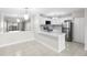 Modern kitchen featuring white cabinets, quartz countertops, stainless steel appliances, and open floor plan at 5618 Baywater Dr # 5618, Tampa, FL 33615