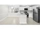 Modern kitchen featuring white cabinets, quartz countertops, stainless steel appliances, and tile flooring at 5618 Baywater Dr # 5618, Tampa, FL 33615