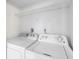 Laundry room with side-by-side washer and dryer and a wire shelf at 5618 Baywater Dr # 5618, Tampa, FL 33615