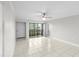 Bright living room with tile flooring, ceiling fan, and sliding glass doors to screened patio and canal view at 5618 Baywater Dr # 5618, Tampa, FL 33615