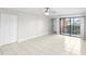 Bright open concept featuring tile flooring, ceiling fan, closet, and sliding glass doors to patio at 5618 Baywater Dr # 5618, Tampa, FL 33615