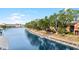 Scenic waterfront view with private docks and walkway lined by mature trees leading to residences at 5618 Baywater Dr # 5618, Tampa, FL 33615