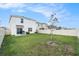 Large backyard featuring a grassy area, partial fence, and a patio for outdoor entertaining at 5640 Wandering Willow Dr, Wesley Chapel, FL 33545