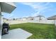 Secluded fenced backyard with lush green grass, offering privacy and space for outdoor enjoyment at 5640 Wandering Willow Dr, Wesley Chapel, FL 33545