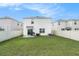 Large, fenced backyard with a patio area, perfect for grilling and outdoor entertaining at 5640 Wandering Willow Dr, Wesley Chapel, FL 33545