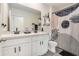 Modern bathroom features a double sink vanity, matte black fixtures, and stylish shower with shower curtain at 5640 Wandering Willow Dr, Wesley Chapel, FL 33545